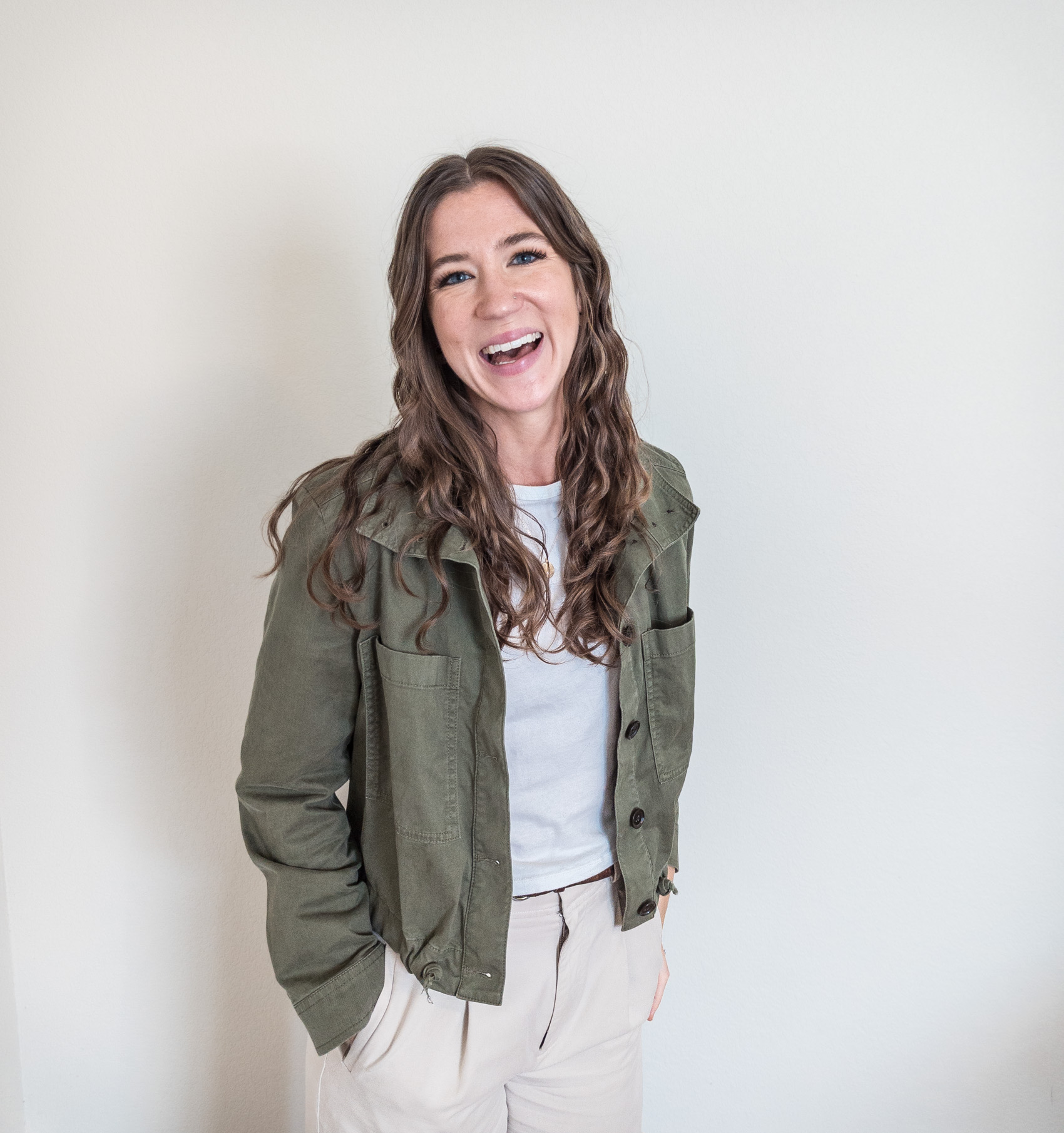 Maria Burke smiling in an olive jacket